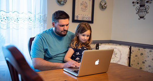 An adult learner takes K-State classes from his dining room table.
