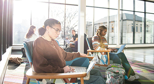 Several students sit in the Multicultural Student Center on the K-State campus.