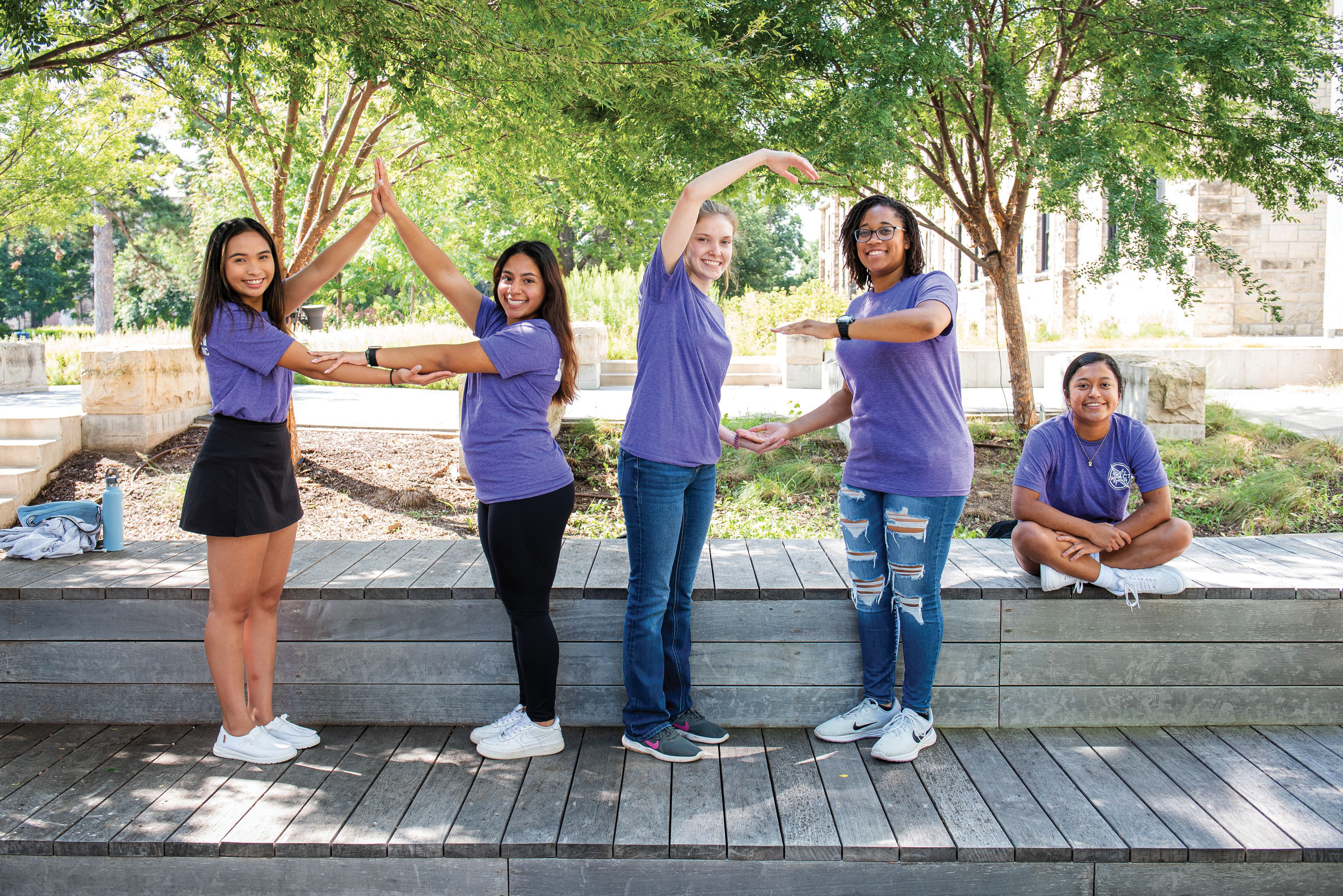 Students spelling AG with their arms