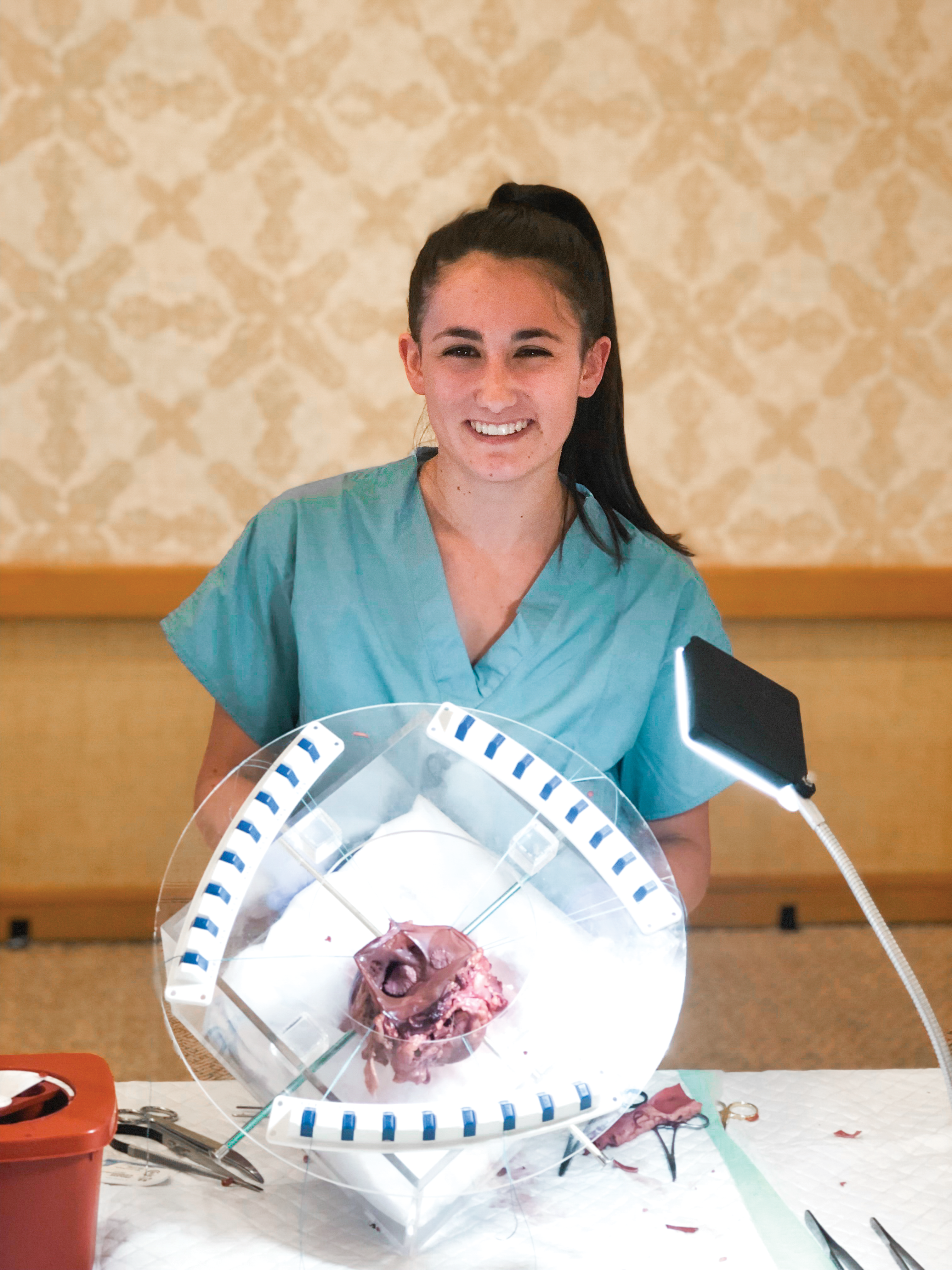 Lola Plum practices surgical techniques on a pig heart