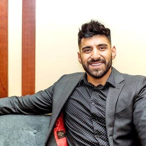 Miguel Ramos, the 2025 Halo Encuentro keynote speaker, wears a black shirt and suit jacket.