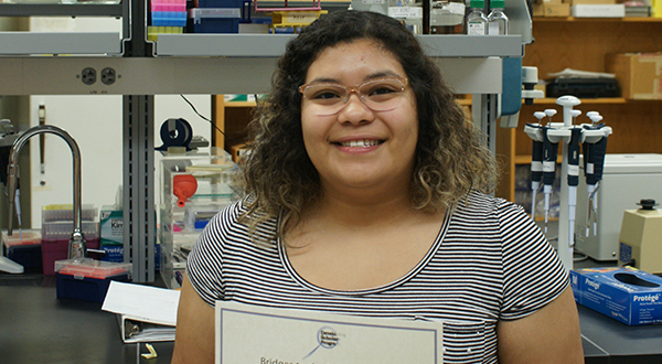 Student with award certificate