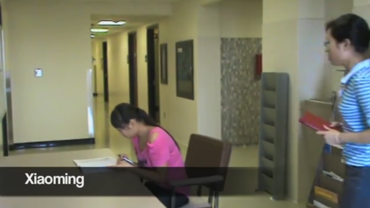 This shows two young women interacting around a book.