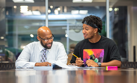 Professor and student reviewing notes