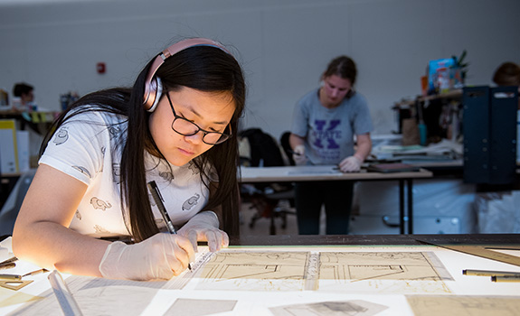 Student working at a drafting table
