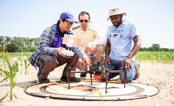 Agriculture students tuning a drone