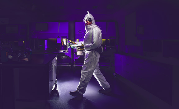 Researcher in hazmat suit in a lab
