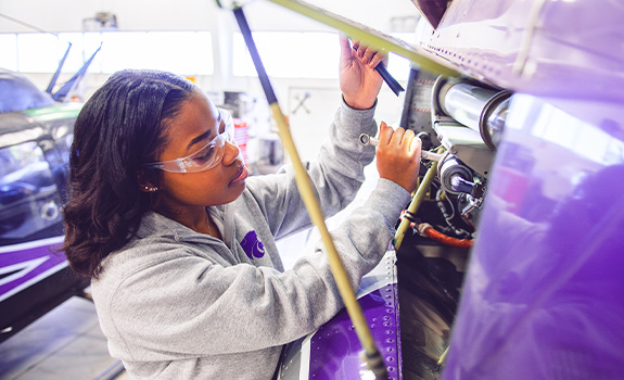 Student tuning up an airplane