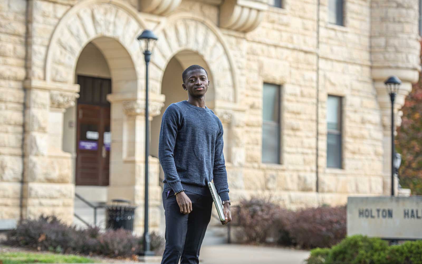 Student in front of Holton Hall.