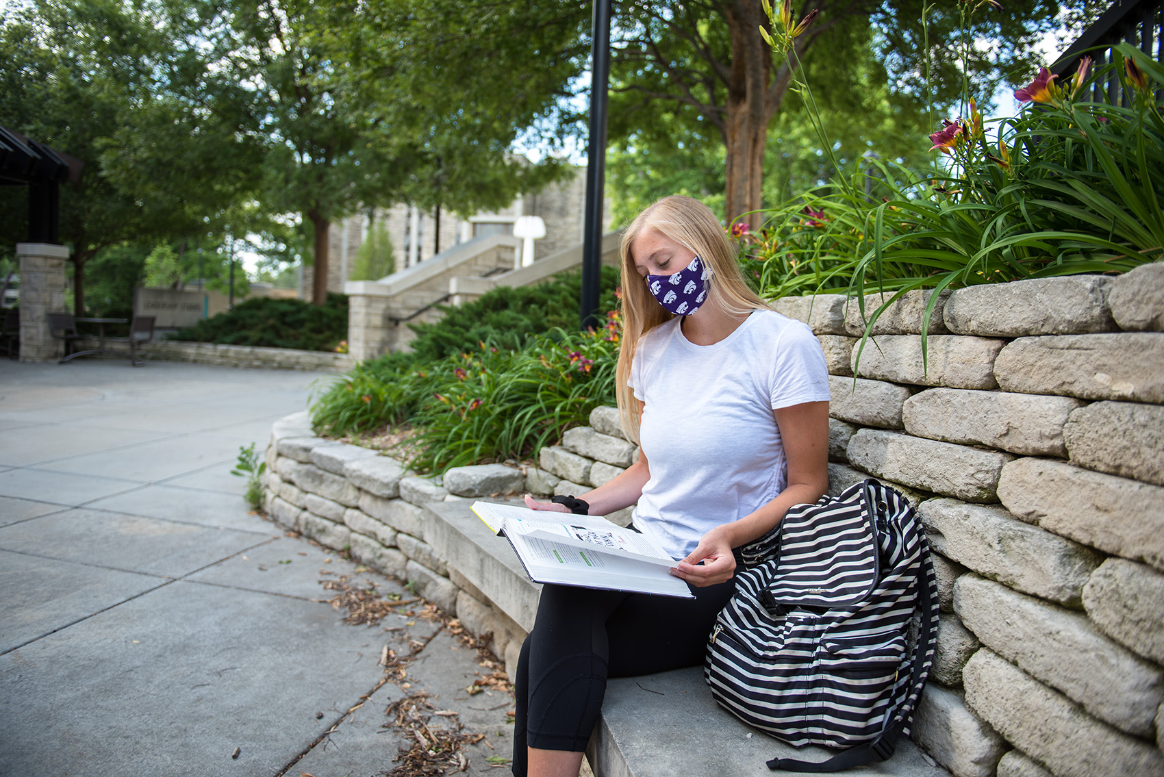 Student in mask studying on campus