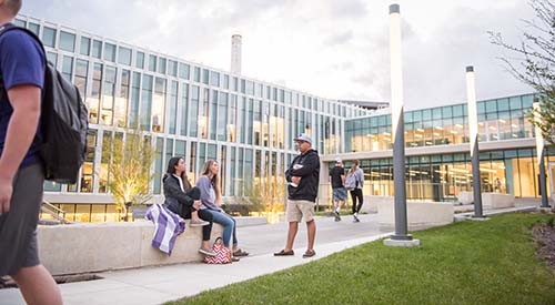 Students sitting outside of Seaton/Regnier Hall