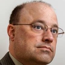 Man with glasses looking pensive