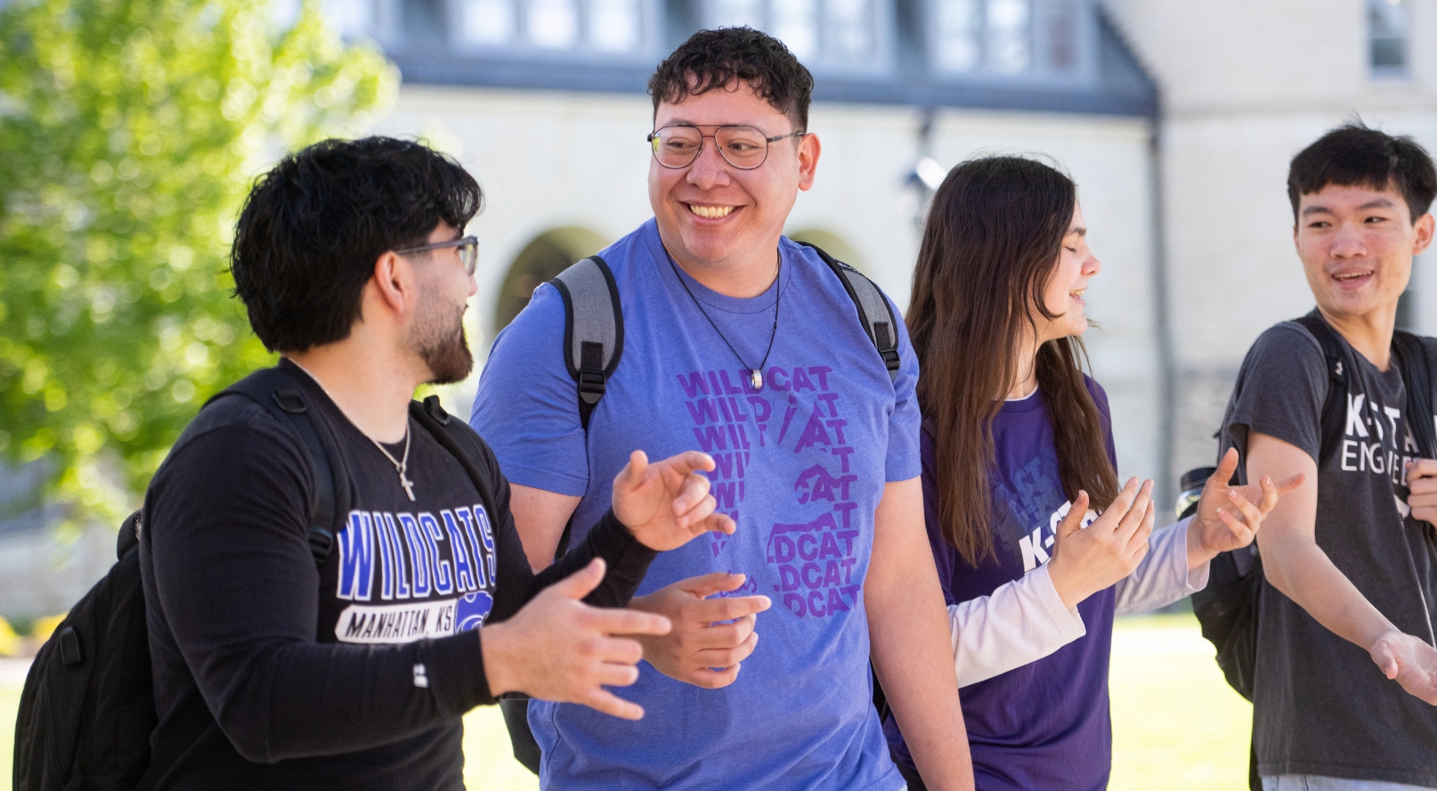 Two students walking, talking and laughing