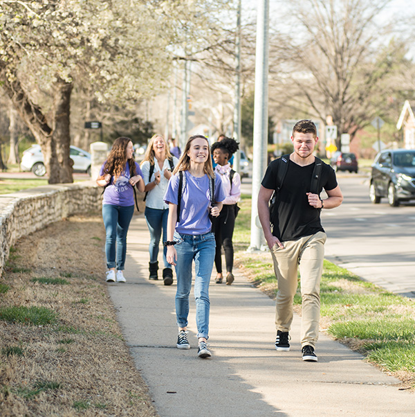 two students walking along north manhattan avenue