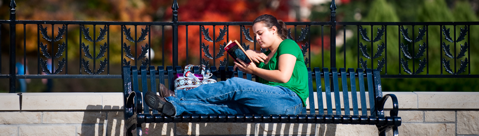 Student Sitting on a Bench Reading