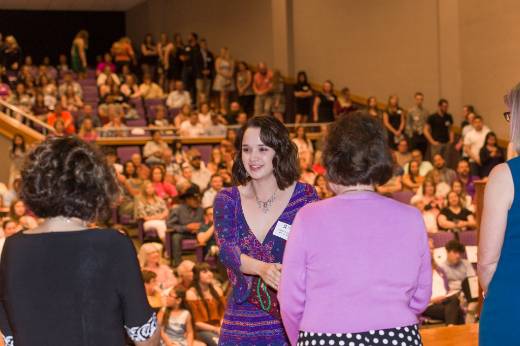 Student receiving green cord