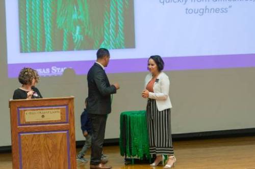 Student receiving green cord