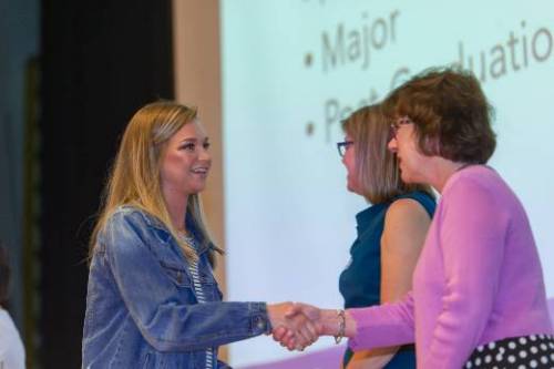 Student receiving green cord