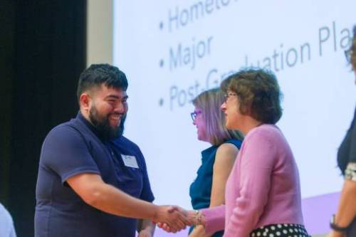 Student receiving green cord