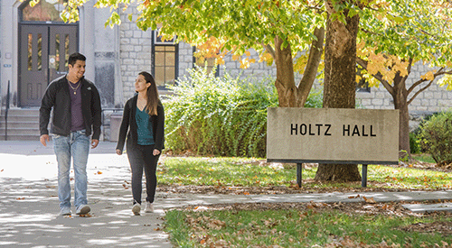 Students walk past Holtz Hall, home of the First-gen Student Center