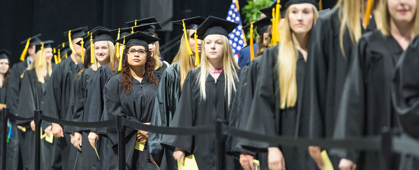 Graduates lined up in caps and gowns