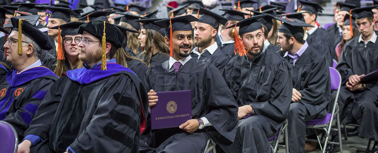 Smiling graduate with diploma cover