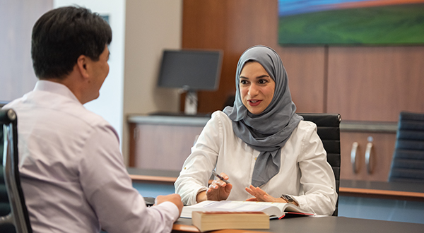 a man and woman discussing a document in front of them