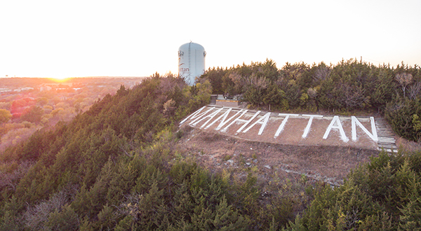 Manhattan hill with the water tower and stones spelling the town's name