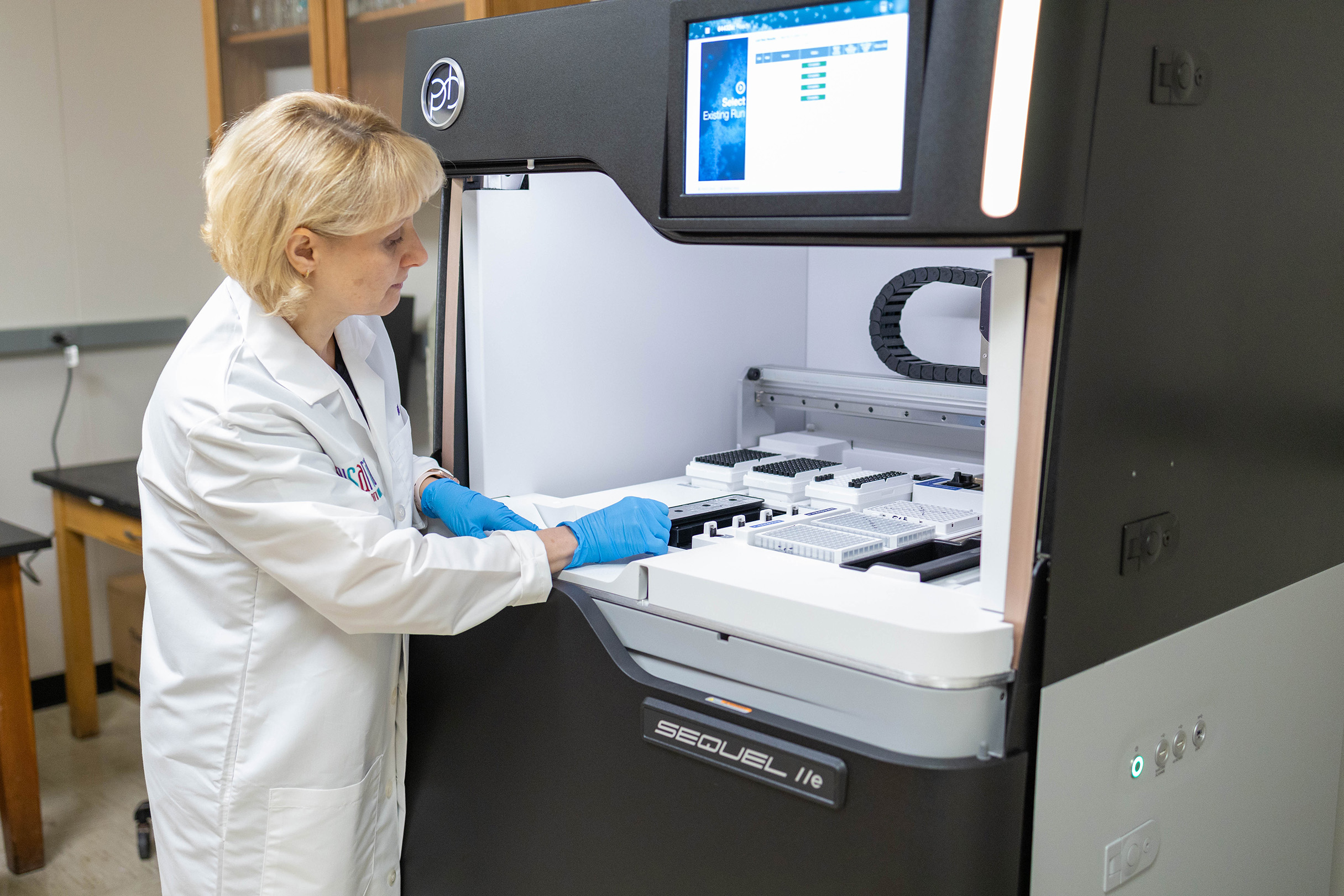 Alina Akhunova adding research medium to PacBio machine