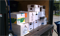 Boxes of paper await shredding on the back of a Document Resources truck