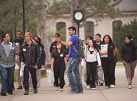 Miguel Ramos, Garden City, Kan., a junior majoring in business marketing, gives high school students a campus tour during an April 2011 College for a Day visit.