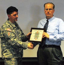 Daryl Youngman, associate professor, libraries, receives a certificate of appreciation from Lt. Col David Wood, deputy commander, 4th IBCT at the Above The Line Symposium at Hale Library,