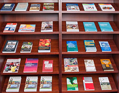 Bookshelf filled with faculty members' books.