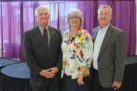 Linda (middle) and Robert (right) Haller gifted ,000 to create the Dennis Kuhlman Student Activity Fund. Kuhlman (left) will retire in June after 15 years as CEO and Dean of K-State Salina.
