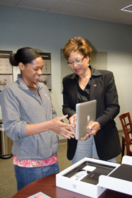 Jasmine Welch receives a laptop from Doris Carroll.