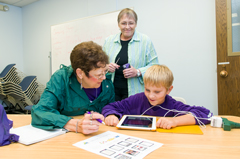 Mary Hammel assists Betty and Dustin Robison