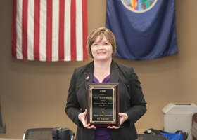 Sharon Brookshire, director of conferences and noncredit programs, accepts the award on behalf of Go Teacher