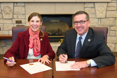 President Kirk Schulz and Provost April Mason sign official proclamation