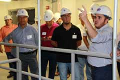 Carlos Campabadal, grain storage and feed manufacturing specialist and course instructor, leads the RAPCO Poultry course participants on a tour of the O.H. Kruse Feed Technology Innovation Center at Kansas State University. 