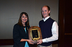 Ann Hess, North American field public relations manager for Alltech, presents the 2014 Forrest Bassford Student Award to Logan Britton.
