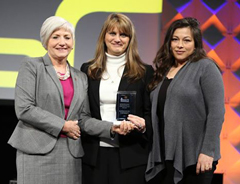 Dean Debbie Mercer and Amanda Morales are presented with the national award. 