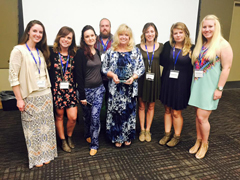 Trina Harlow, art education instructor and art education program coordinator, is surrounded by current and former students when she was presented with the award.