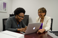 Doris Wright Carroll (right) helps Takara Brownridge set up her new computer. 