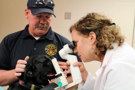 Ashes from Salina Fire Department receives an eye exam from ophthalmologist, Dr. Amy Rankin.