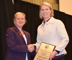 Dean Tammy Beckham presents Elizabeth Davis with the 2016 Dr. William and Deanna Pritchard Veterinary Service and Outreach Award 