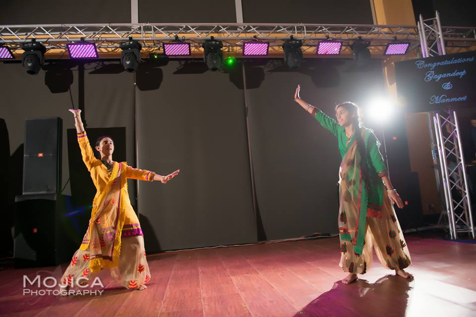 Simrun Hundal and her sister performing Bhangra on stage