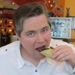 Aaron Dossey eating an insect taco