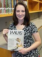 Valerie Head holds the cover of the Journal of the American Association for Laboratory Animal Science.