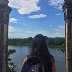 Student looking out over water from an ancient palace in Vietnam.