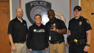 K-State Police Jason Blackburn, Randy Myles and Andrew Koharchik present Alejandro Martinez with gift cards as the second weekly winner of the LiveSafe contest.